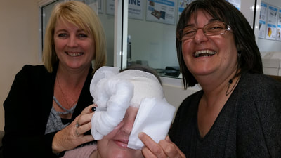 Some wonderful students having a good laugh while practicing their bandaging styles at one of our community courses.