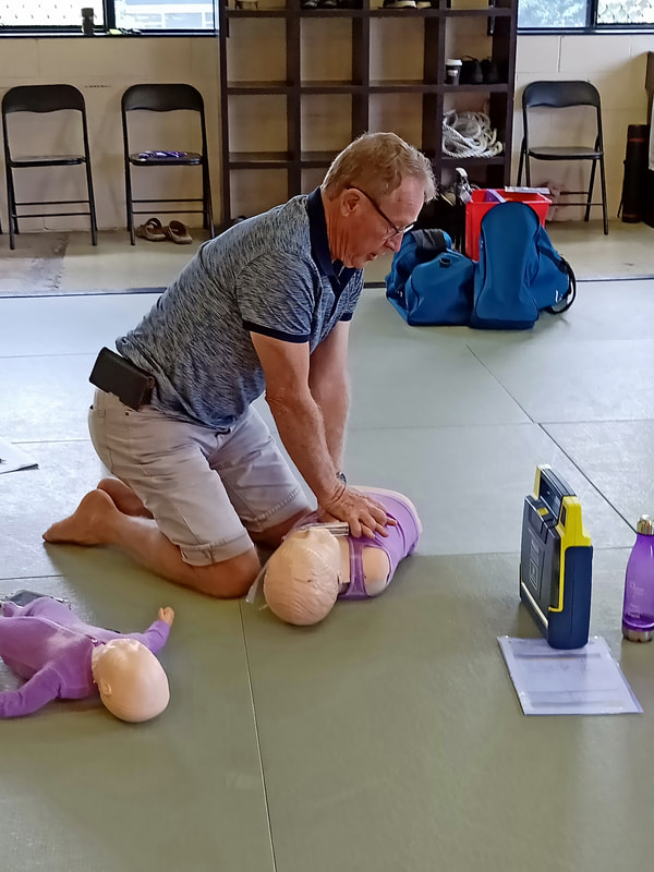CPR practical on a child manikin by a student of B-Ready First Aid in Brisbane.